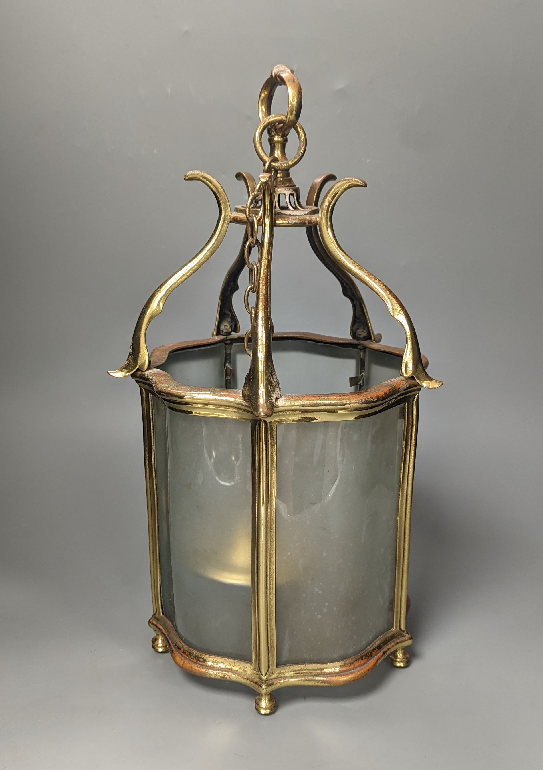 A brass hall lantern and a circular brass ceiling light fitting, hall lantern 40 cms high.